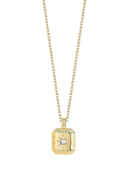 Gold necklace with a square pendant featuring a gemstone on a white background