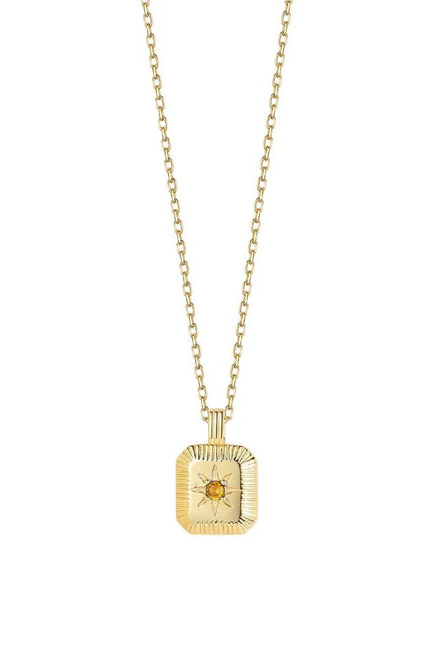 Gold necklace with a square pendant featuring an orange gemstone on a white background