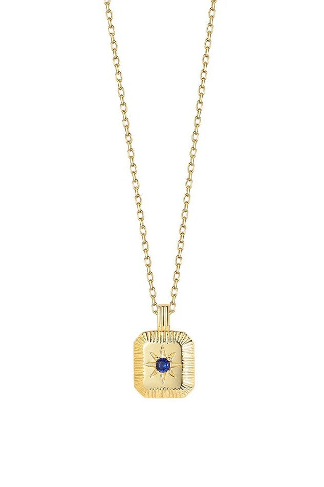 Gold necklace with a square pendant featuring a blue gemstone on a white background