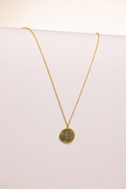 Gold necklace with a pendant on a white background