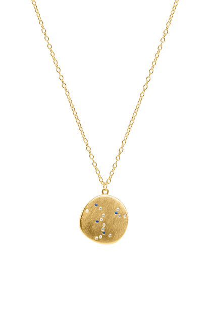 Gold necklace with a round pendant on a white background