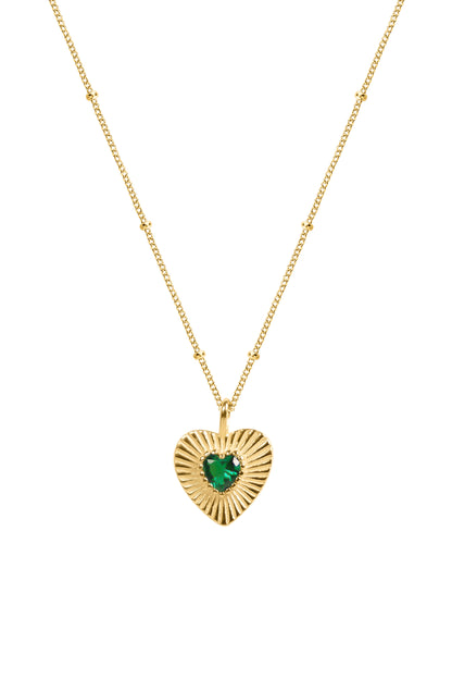Gold heart-shaped pendant with a green gemstone on a white background