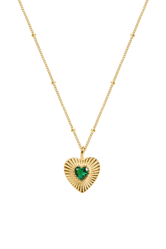 Gold heart-shaped pendant with a green gemstone on a white background