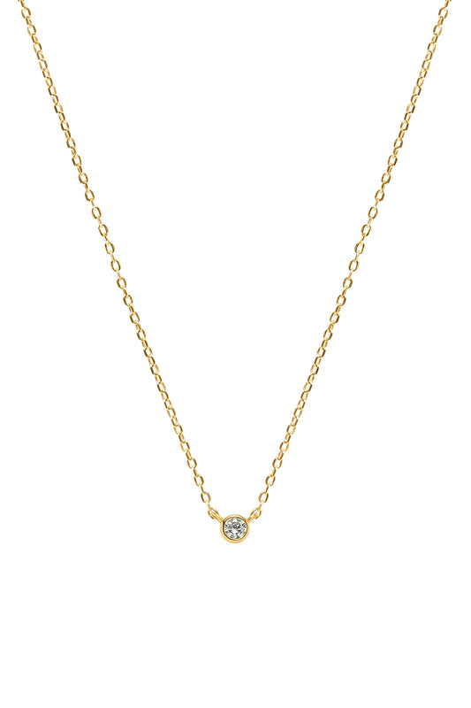 Gold necklace with a small round gemstone pendant on a white background
